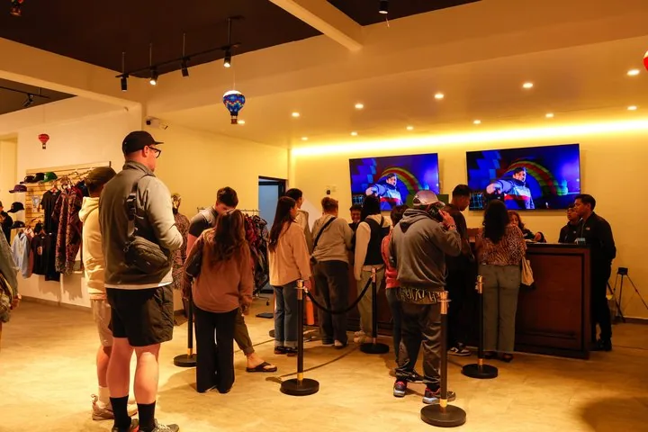 Visitors queuing at a counter inside the operator's bright reception building